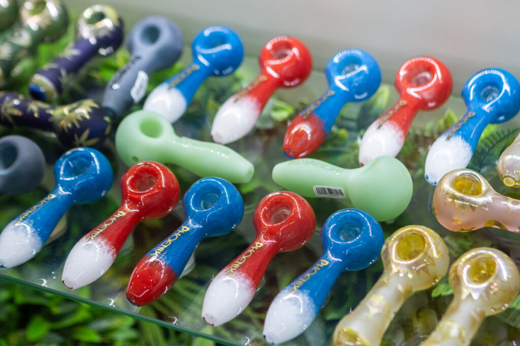 Blue, green, and red glass pipes used to smoke cannabis flower